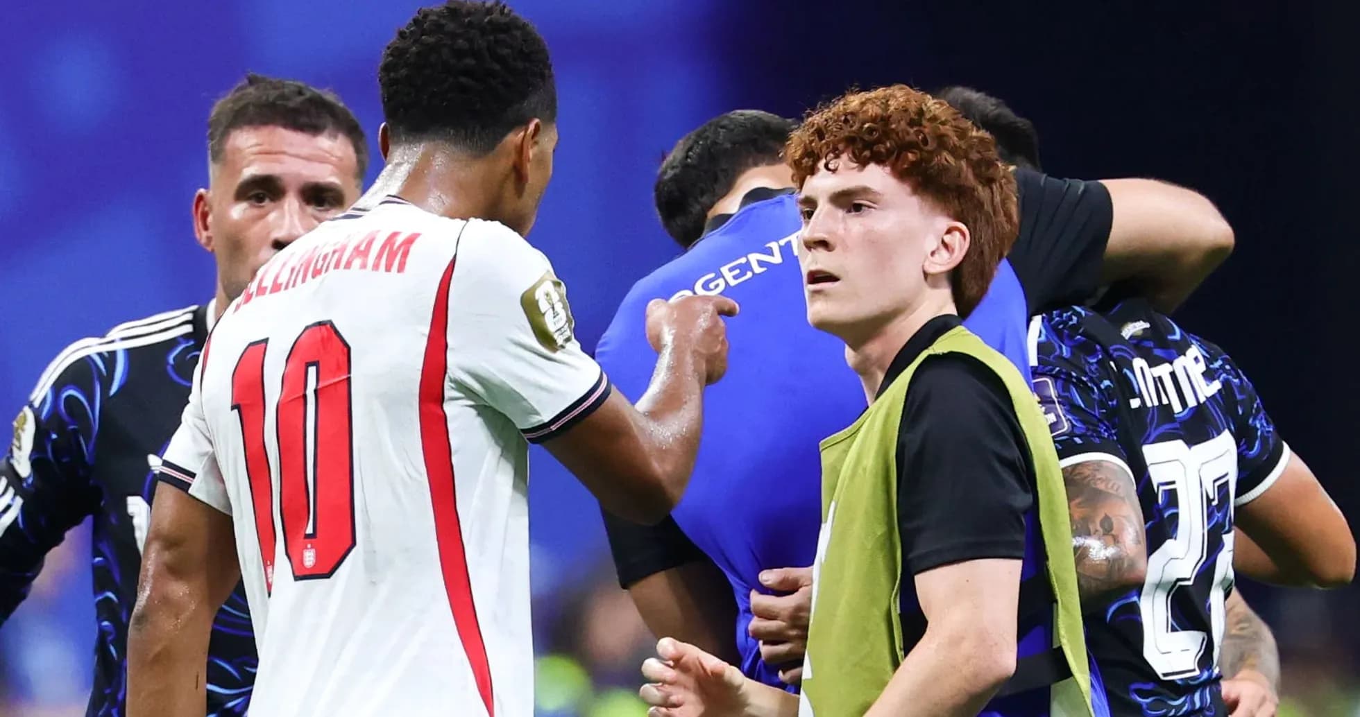 Players interacting on the pitch during a match Players interacting on the pitch during a match