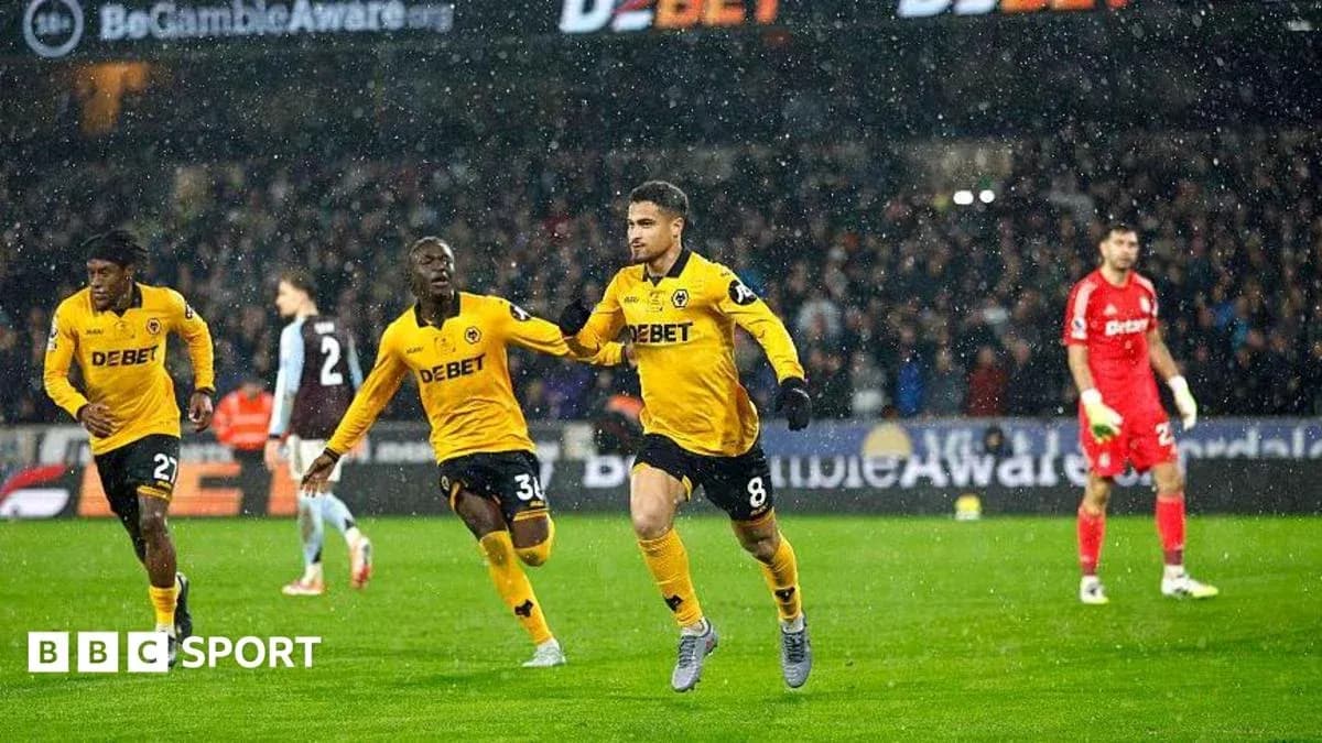 Player celebrating goal during match in rain Player celebrating goal during match in rain