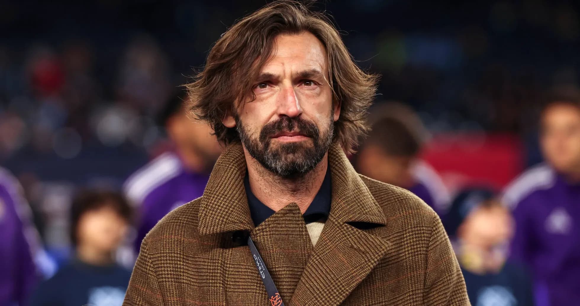 Man with long hair wearing a brown coat Man with long hair wearing a brown coat