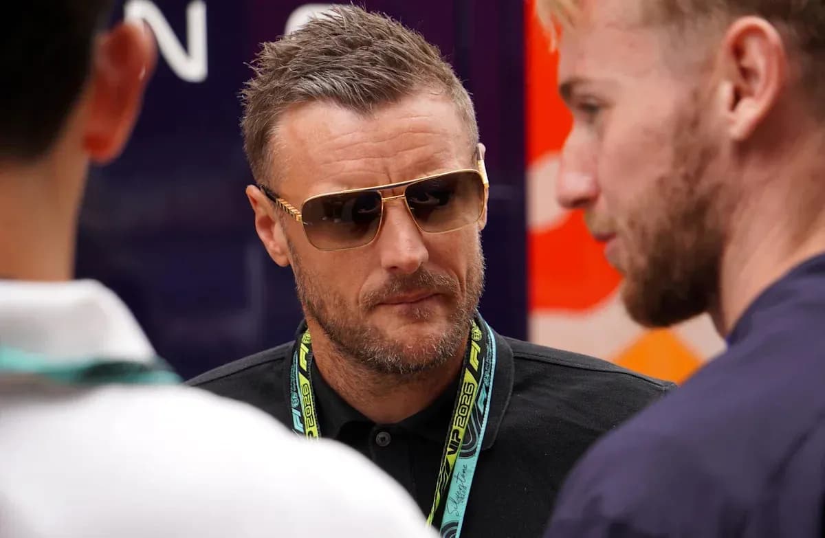 Man in sunglasses talking to two others Man in sunglasses talking to two others