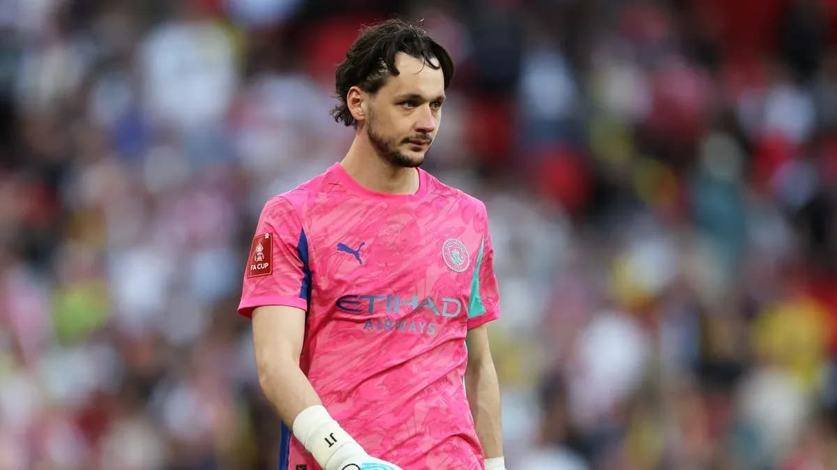 Goalkeeper in pink kit walking on pitch Goalkeeper in pink kit walking on pitch