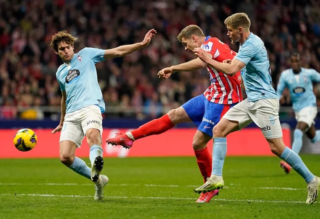 Atletico Madrid player striking the ball Atletico Madrid player striking the ball