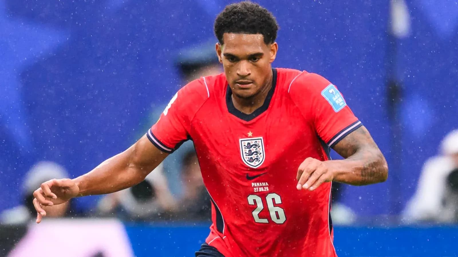Player in red England jersey running during match Player in red England jersey running during match