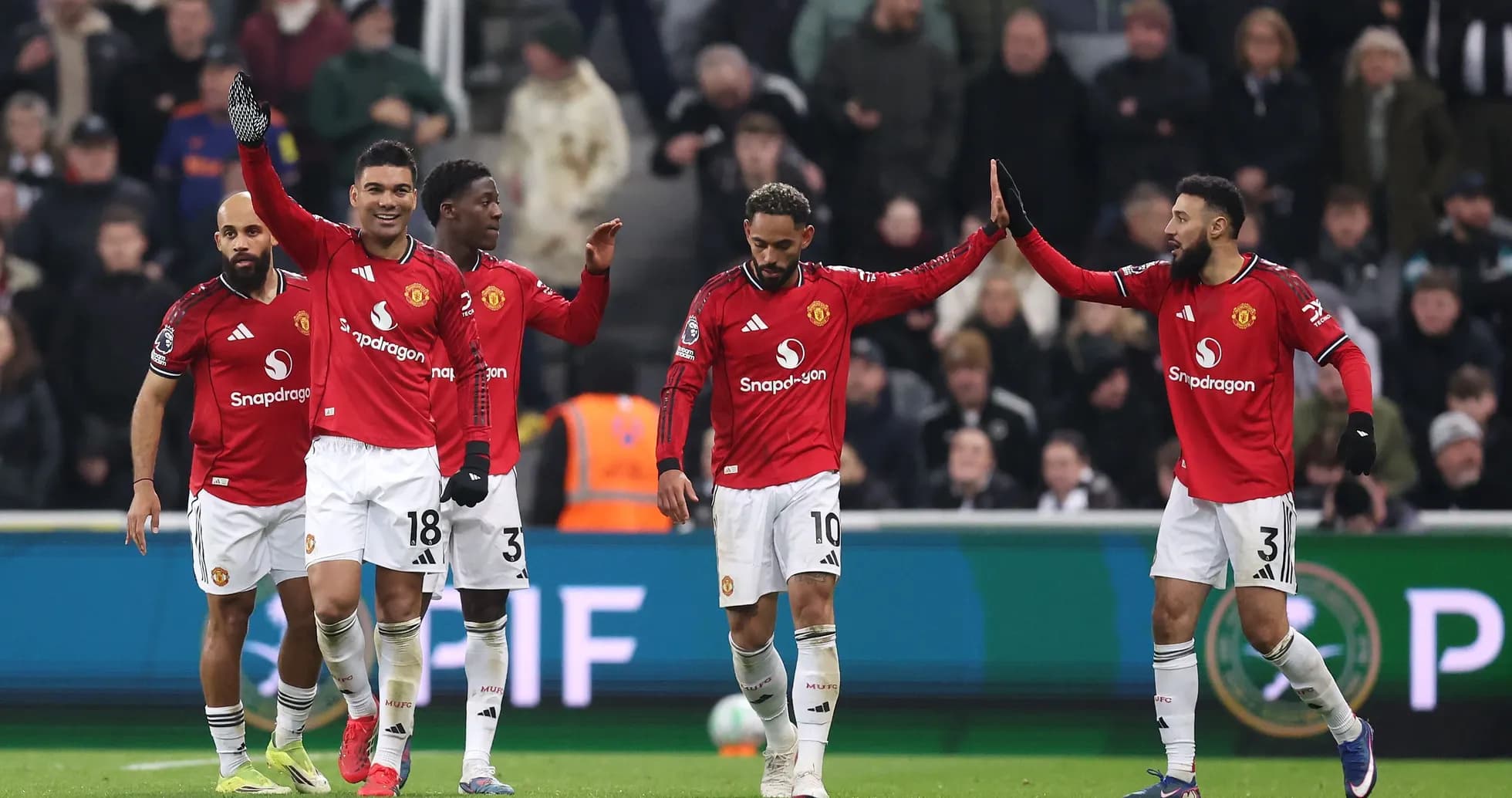 Manchester United players celebrating a goal together Manchester United players celebrating a goal together