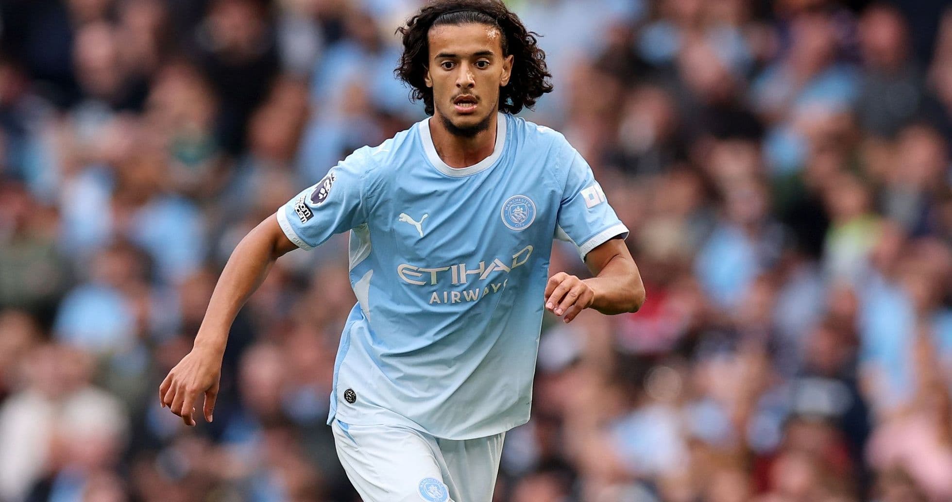 Player running with ball during Manchester City match Player running with ball during Manchester City match