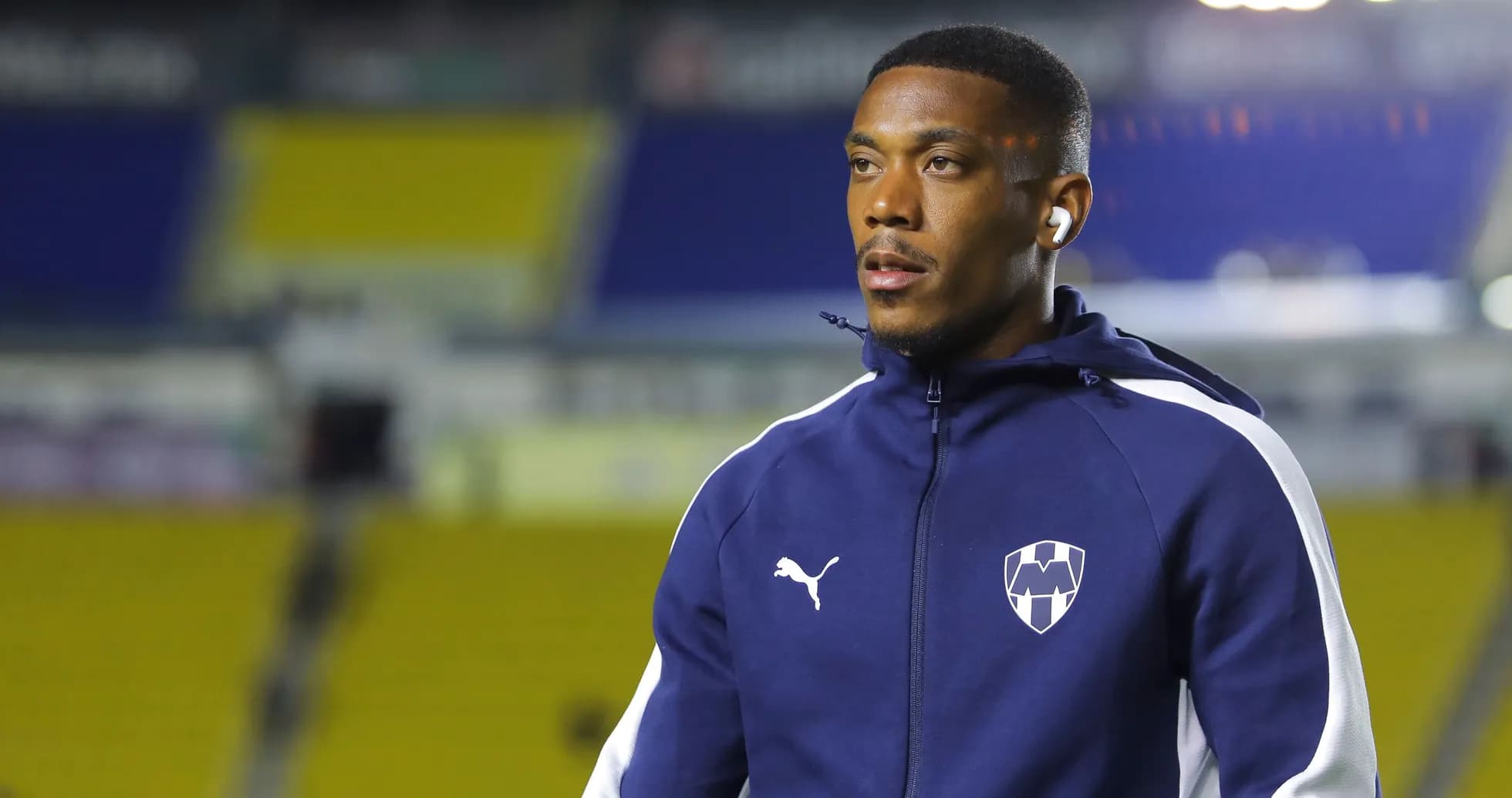 Player wearing headphones during warm-up on pitch Player wearing headphones during warm-up on pitch