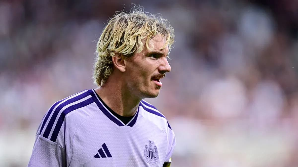 Newcastle player in purple kit during match Newcastle player in purple kit during match