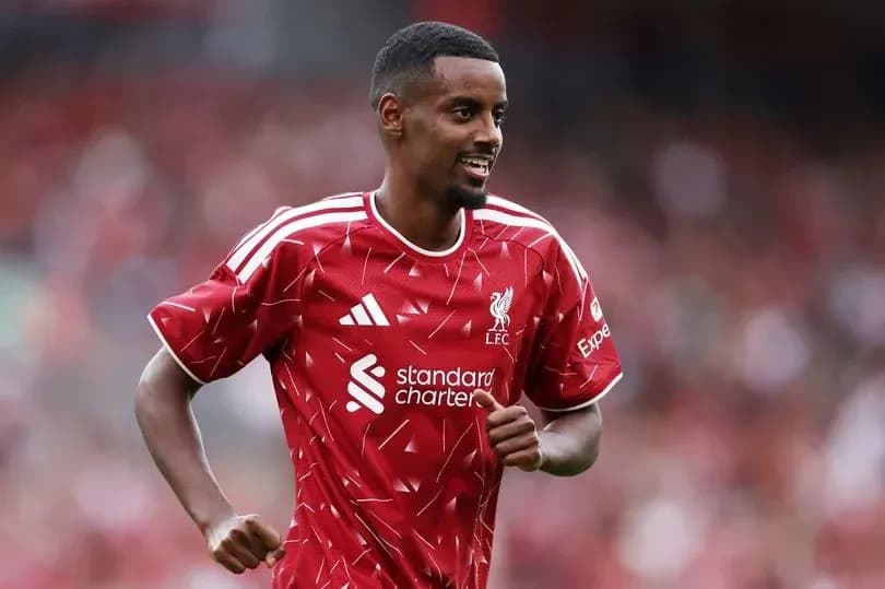 Player in Liverpool kit celebrating on the field Player in Liverpool kit celebrating on the field