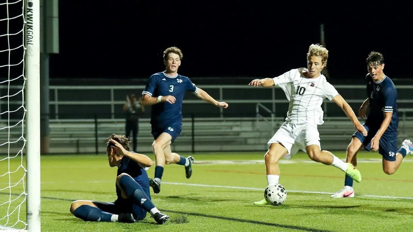 Player attempting to score as goalie defends Player attempting to score as goalie defends