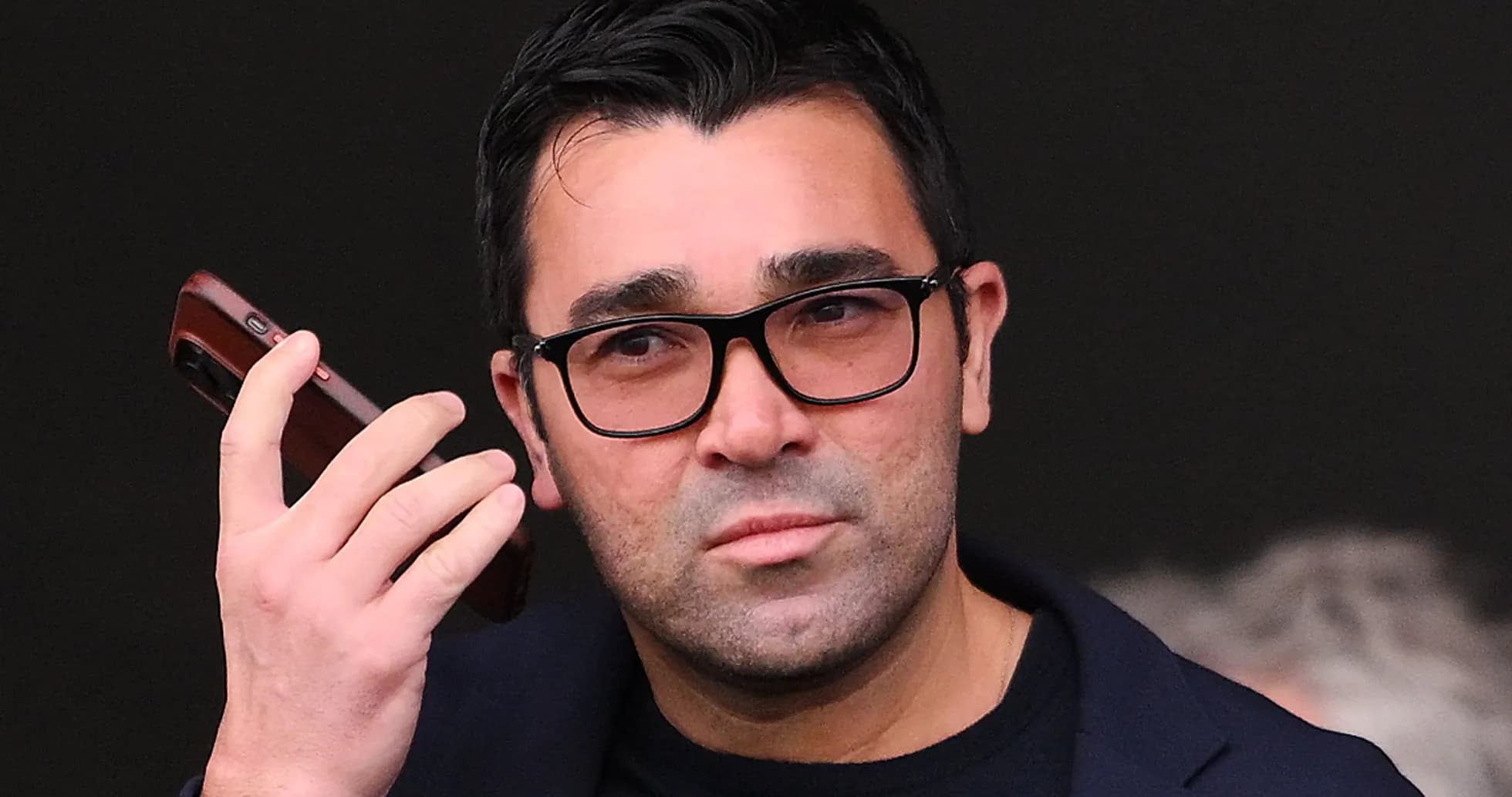 Man holding a phone, looking intently Man holding a phone, looking intently