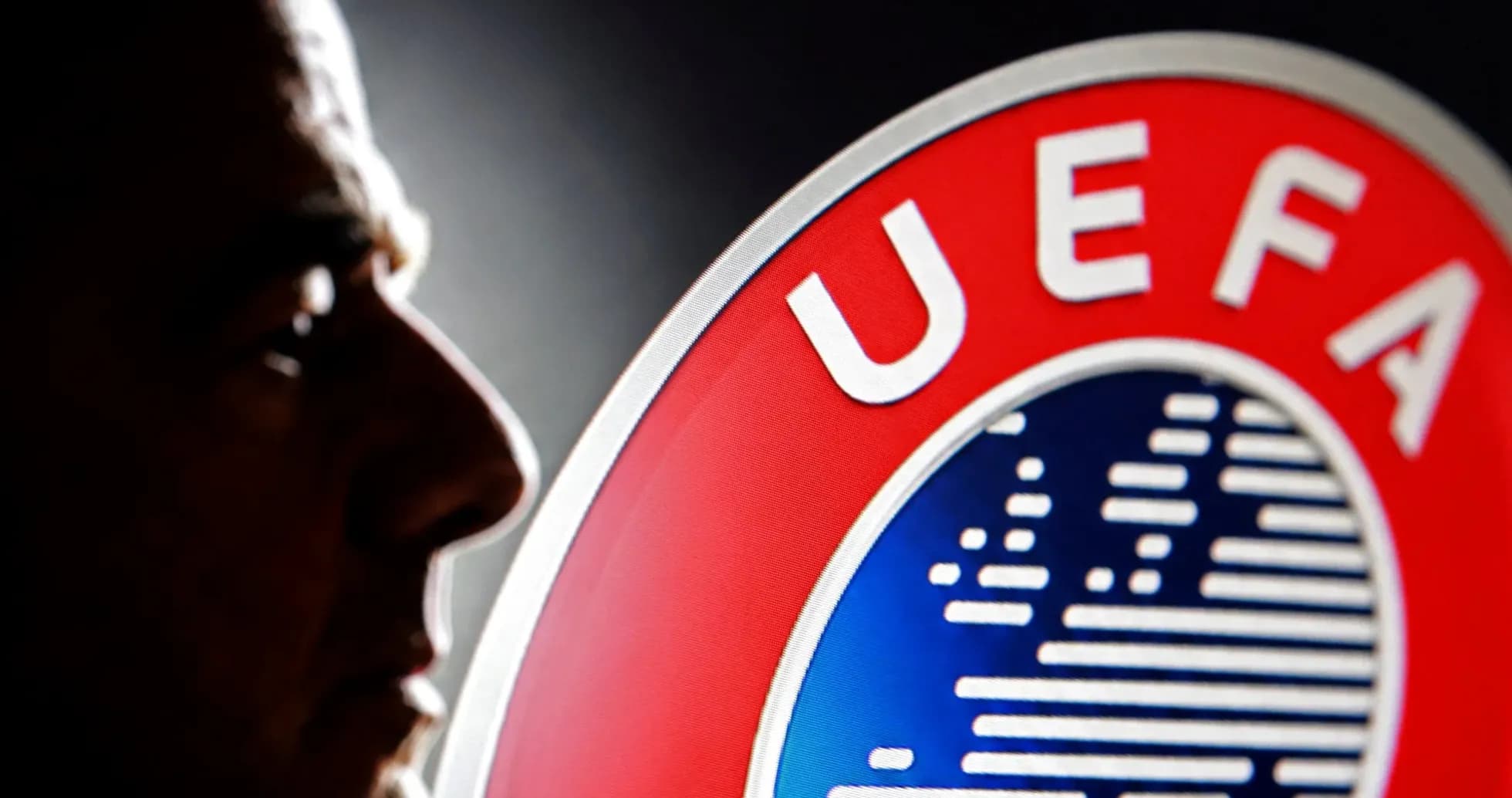 Silhouette of a man beside UEFA logo Silhouette of a man beside UEFA logo