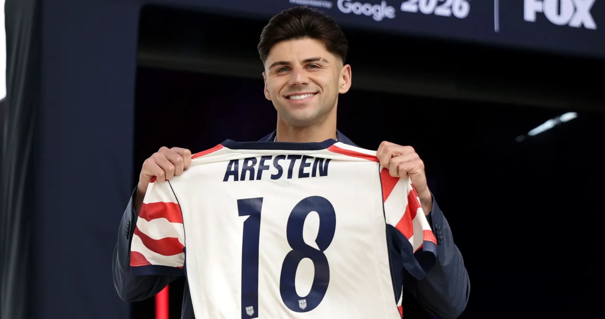 Player holding jersey with name Arfsten and number 18 Player holding jersey with name Arfsten and number 18