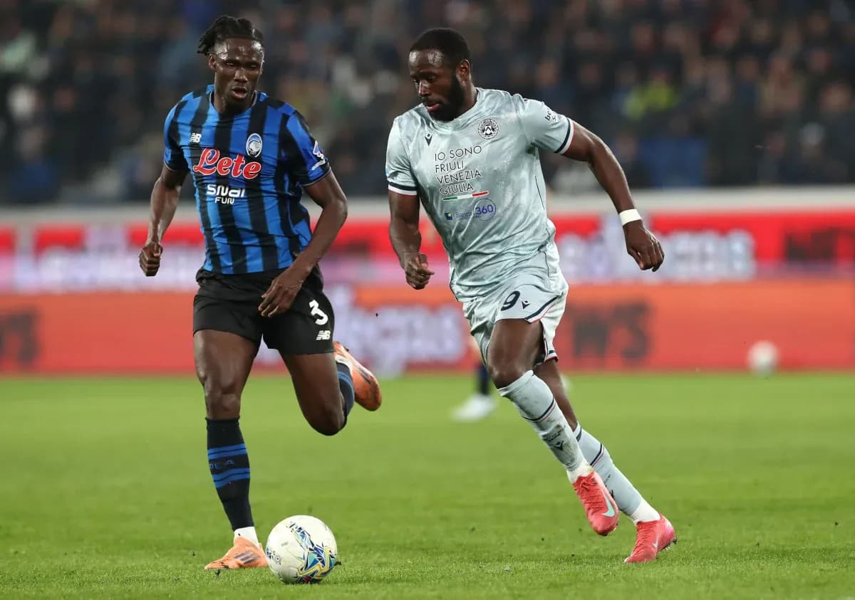 Atalanta player tackling Udinese opponent Atalanta player tackling Udinese opponent