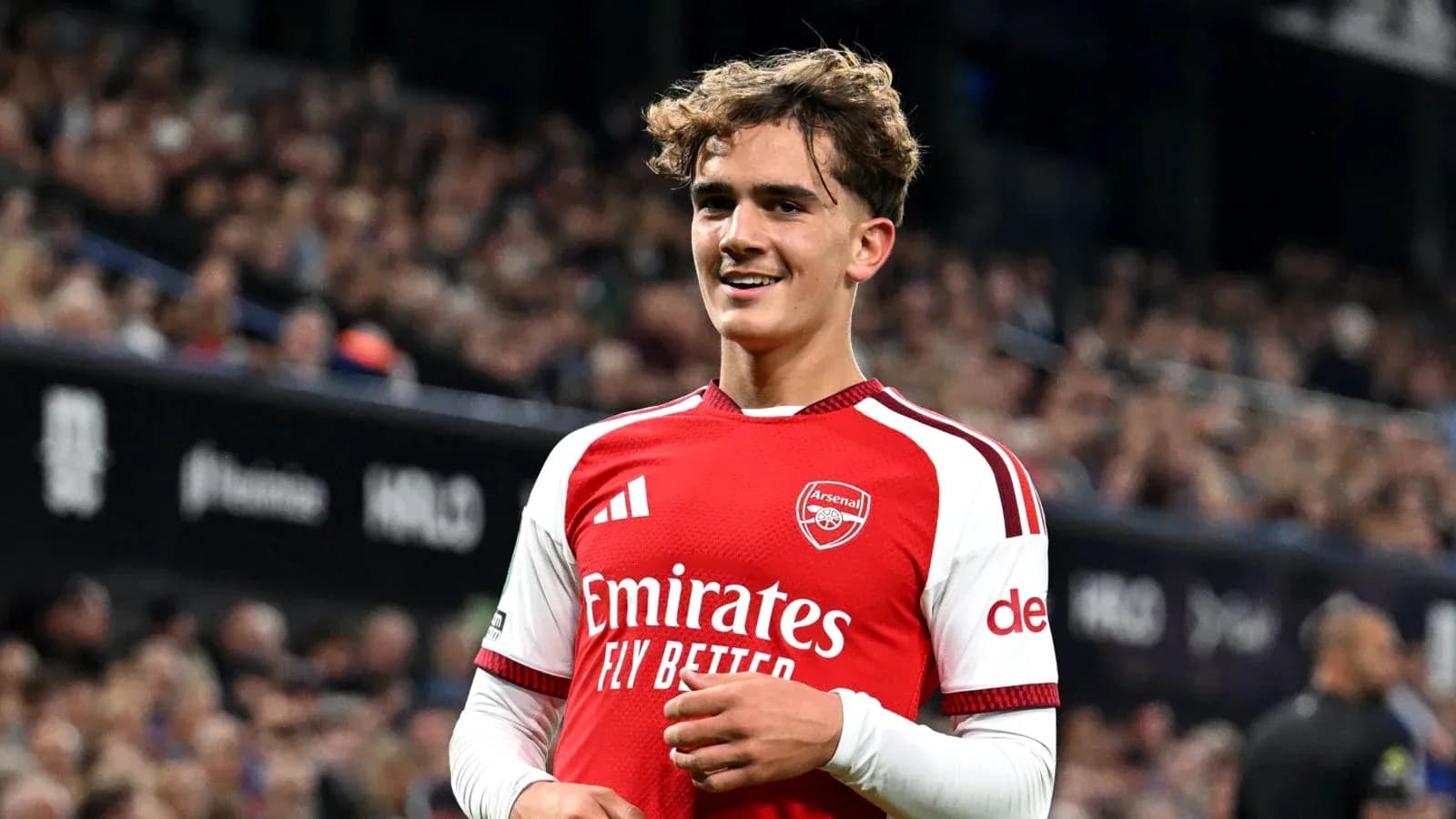 Arsenal player smiling during a match Arsenal player smiling during a match