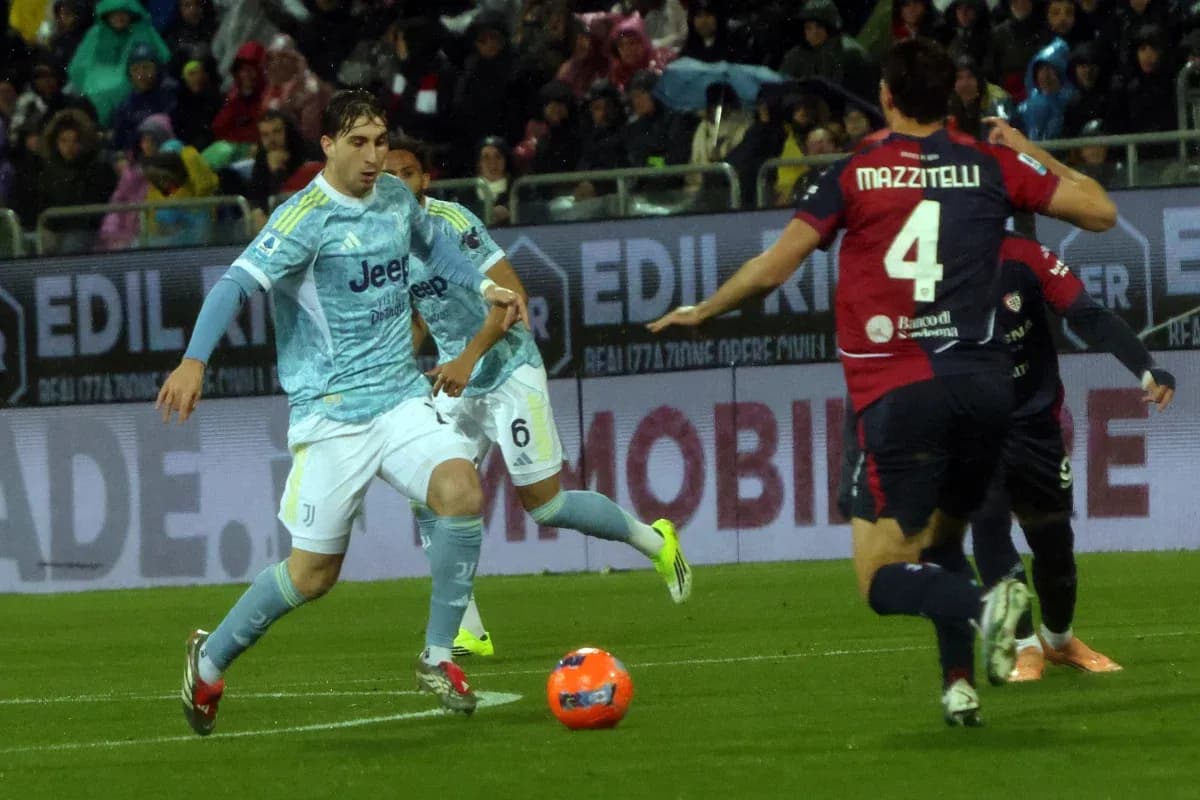 Juventus player dribbling past Cagliari defender Juventus player dribbling past Cagliari defender