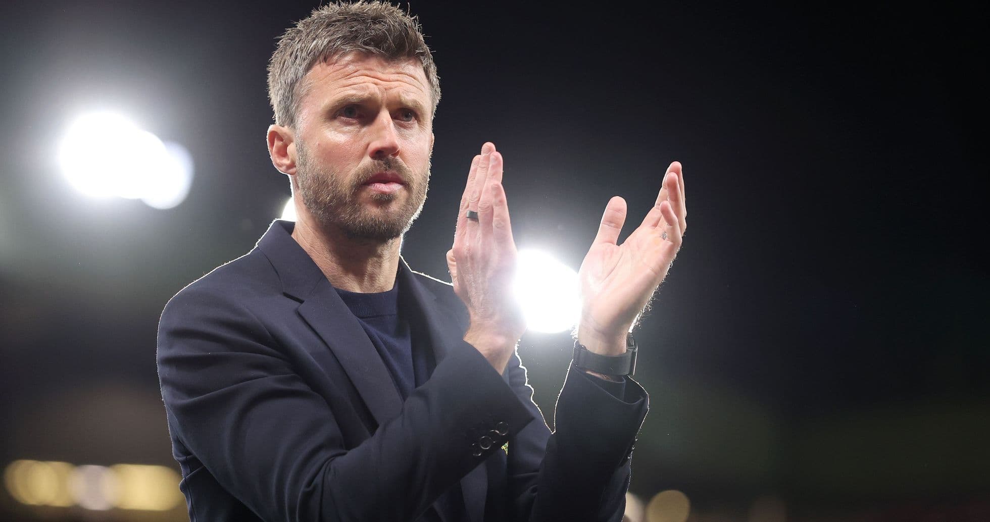 Coach applauding in stadium with bright lights Coach applauding in stadium with bright lights