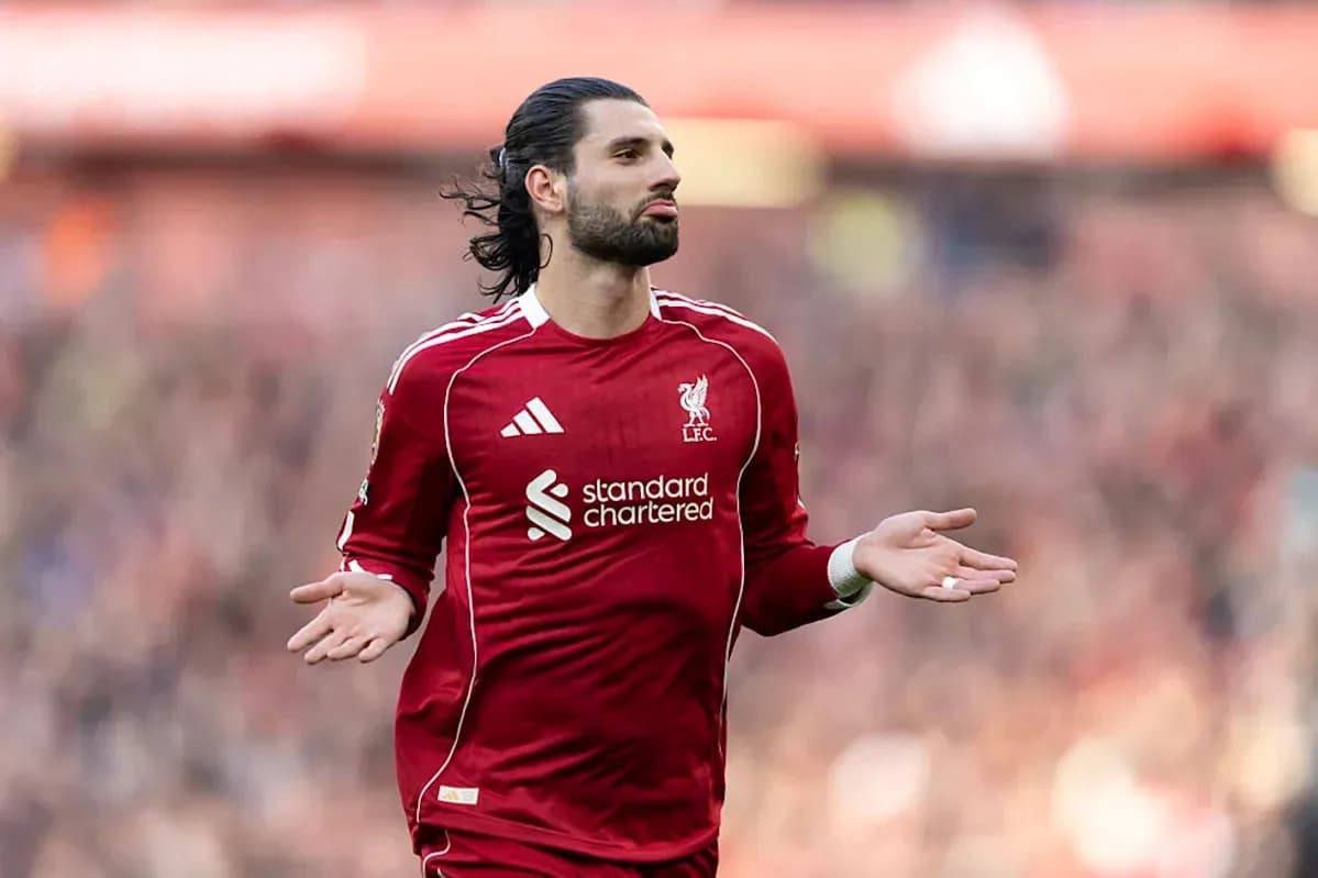 Player gesturing during a match in red kit Player gesturing during a match in red kit