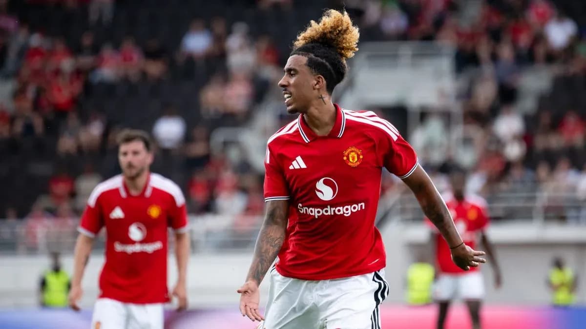 Player celebrating in Manchester United jersey on pitch Player celebrating in Manchester United jersey on pitch