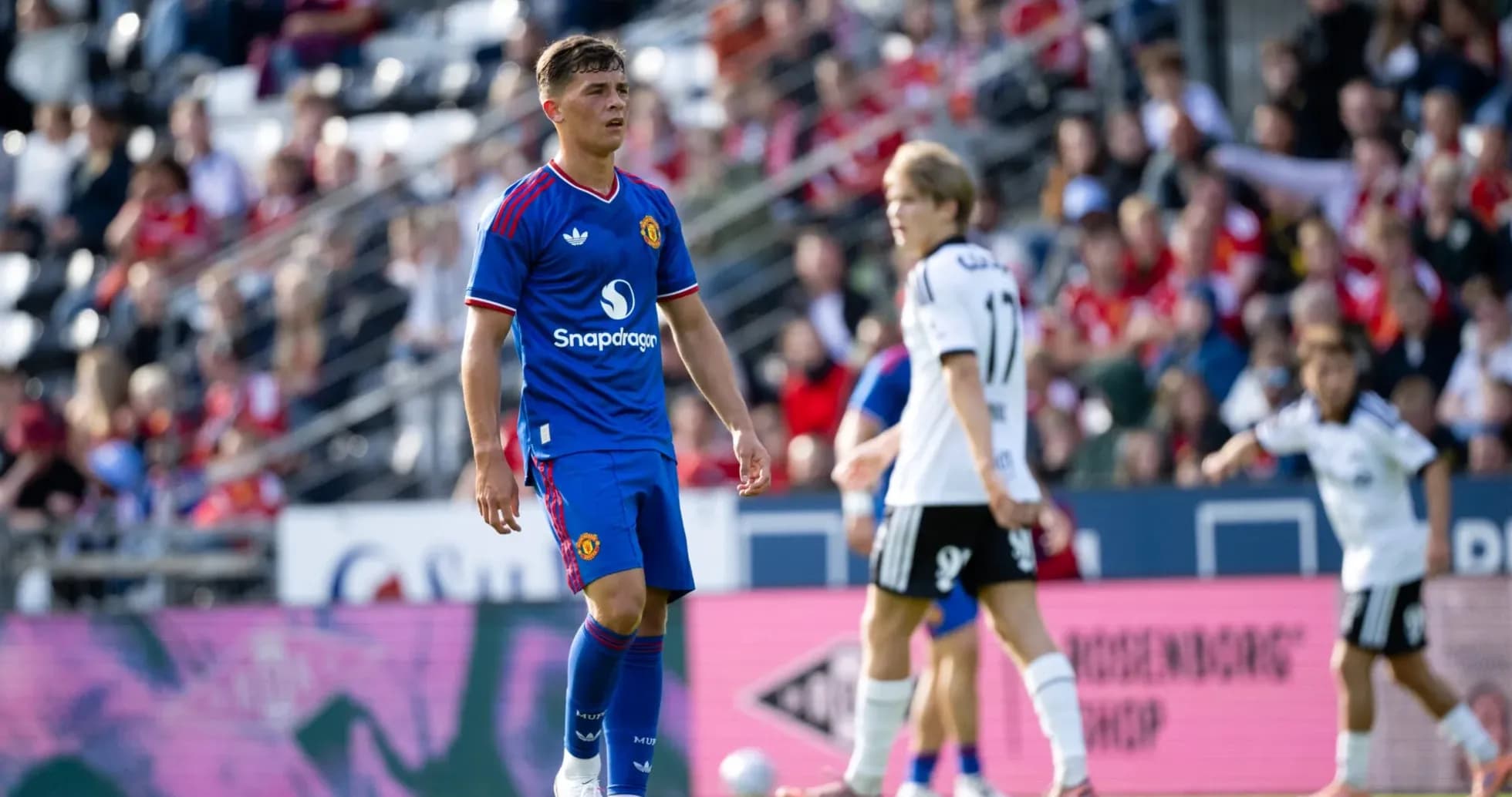 Player in blue Manchester United kit on field Player in blue Manchester United kit on field