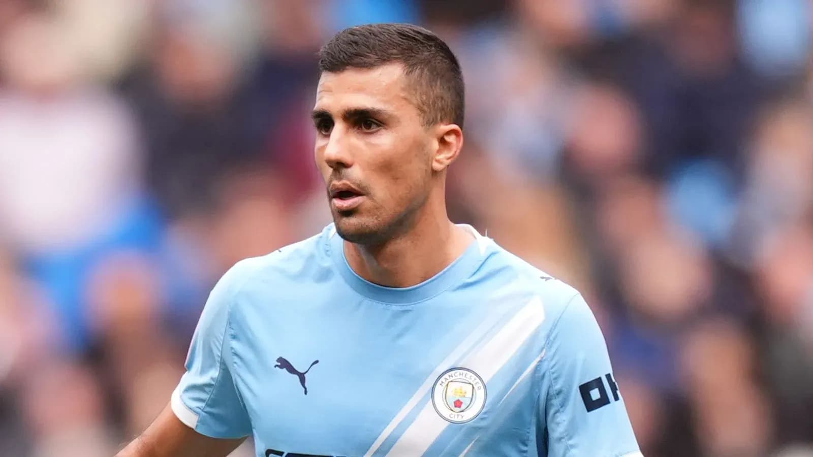 Player wearing Manchester City kit on the field Player wearing Manchester City kit on the field