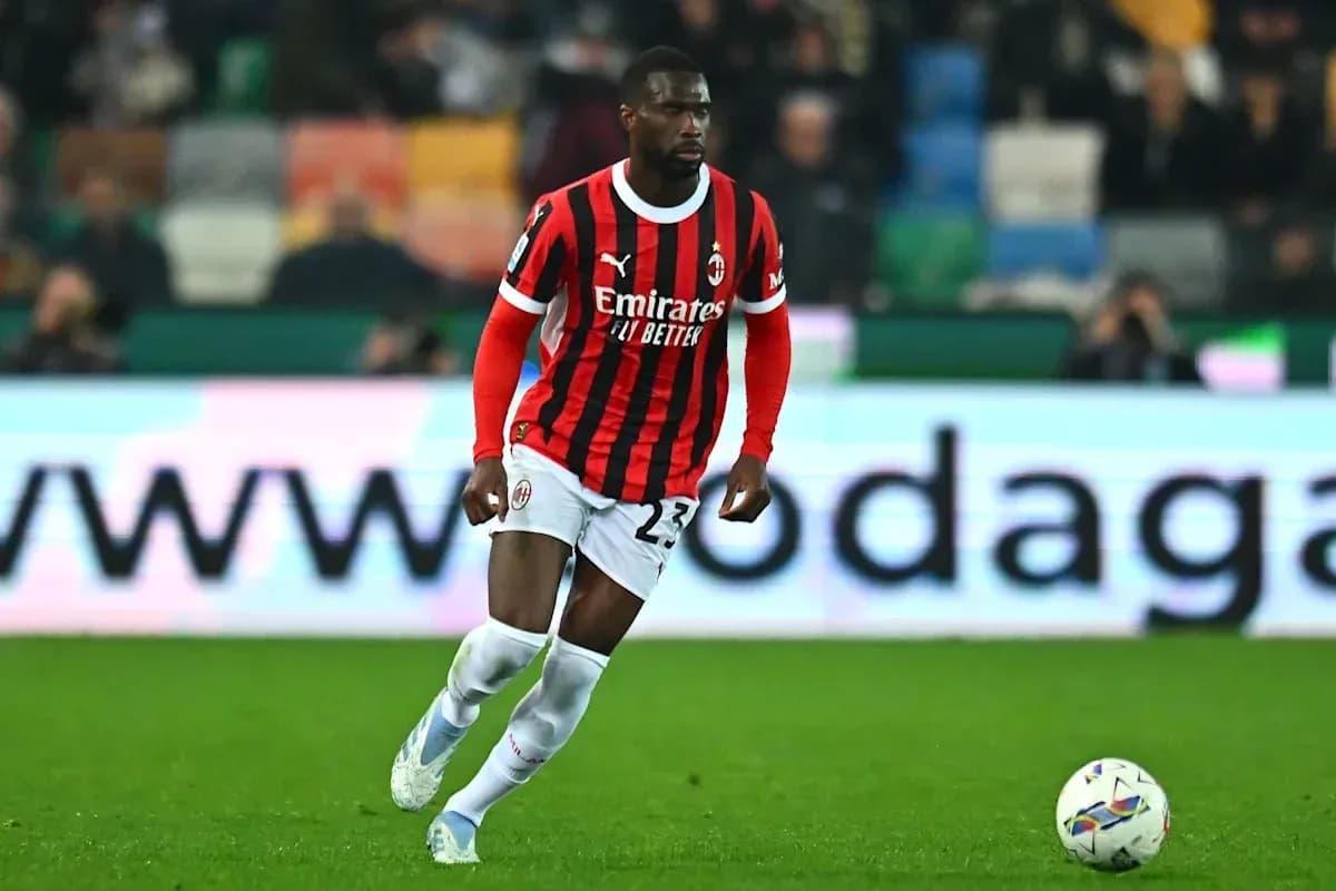 Player in AC Milan jersey dribbling the ball Player in AC Milan jersey dribbling the ball