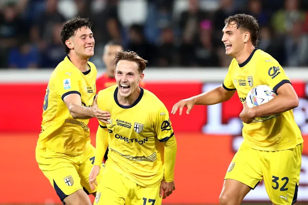 Players celebrating a goal in yellow jerseys Players celebrating a goal in yellow jerseys