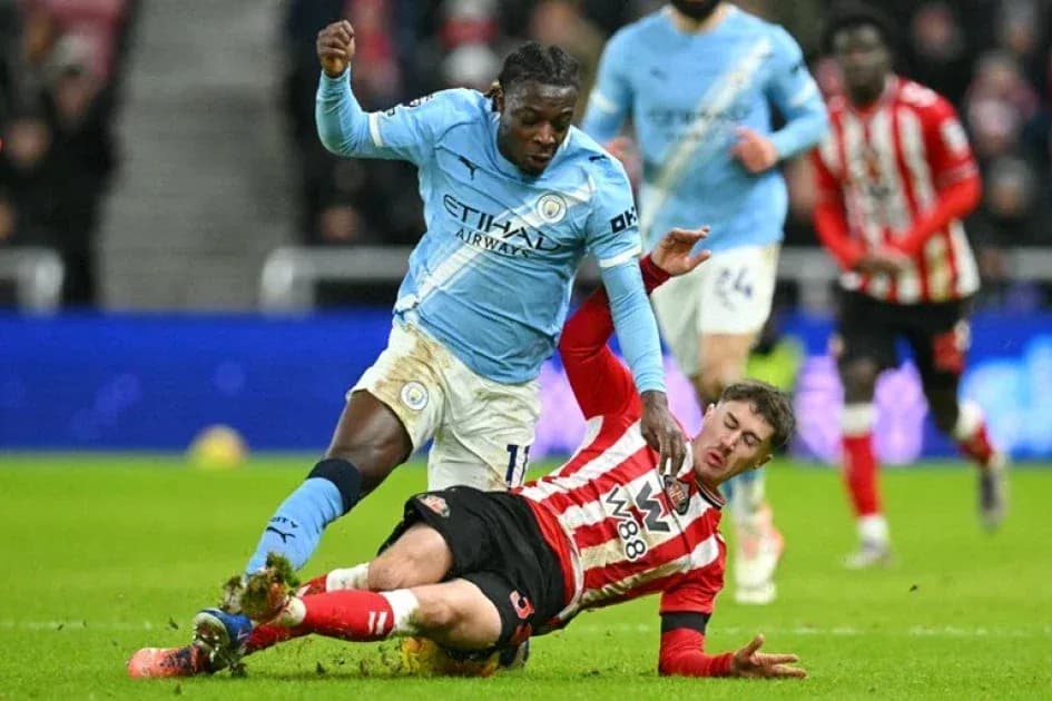 Player from Manchester City tackles Southampton opponent Player from Manchester City tackles Southampton opponent