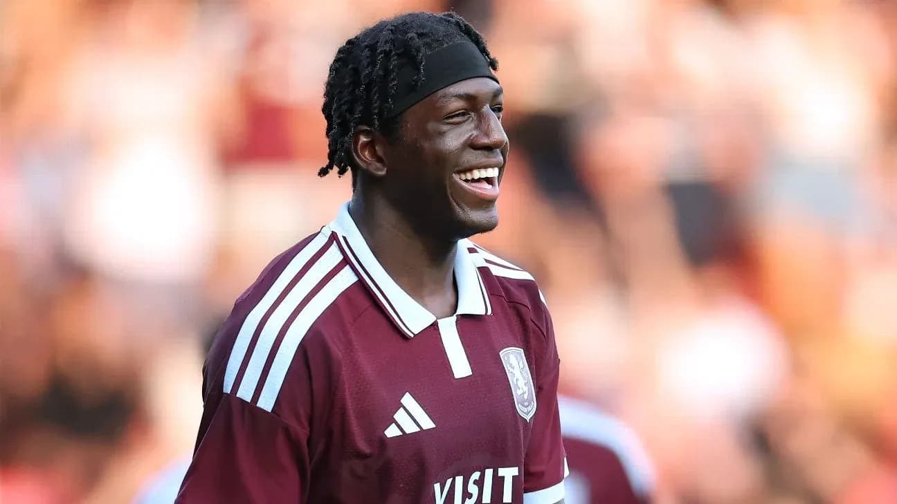 Player smiling in maroon jersey during match Player smiling in maroon jersey during match