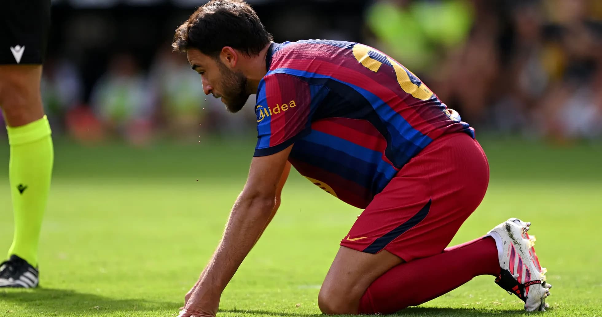 Player kneeling on the field during a match Player kneeling on the field during a match