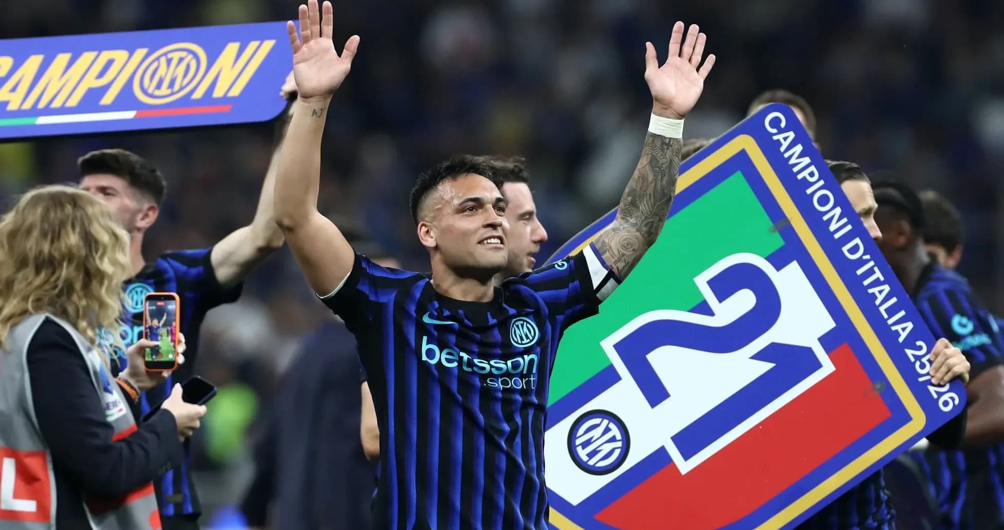 Player celebrating with championship banner after match Player celebrating with championship banner after match