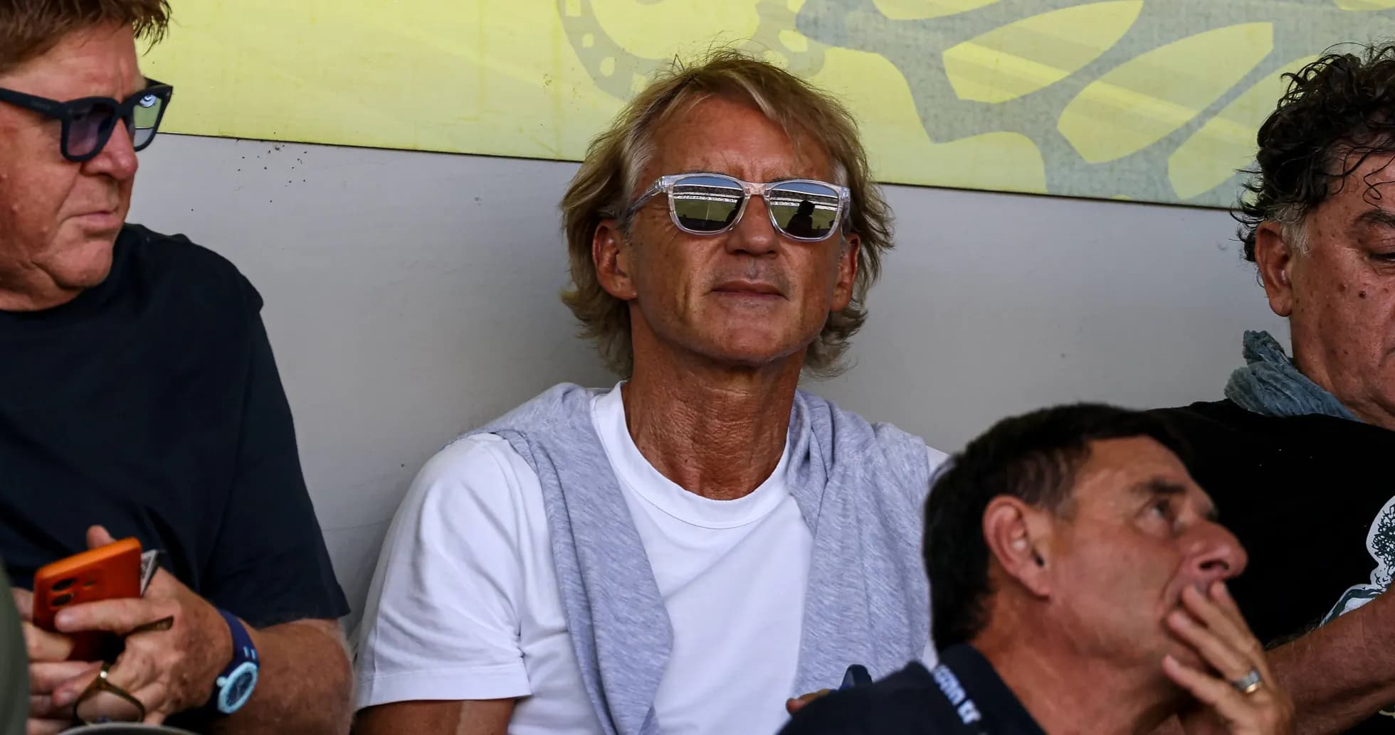 Man wearing sunglasses in stadium seating area Man wearing sunglasses in stadium seating area