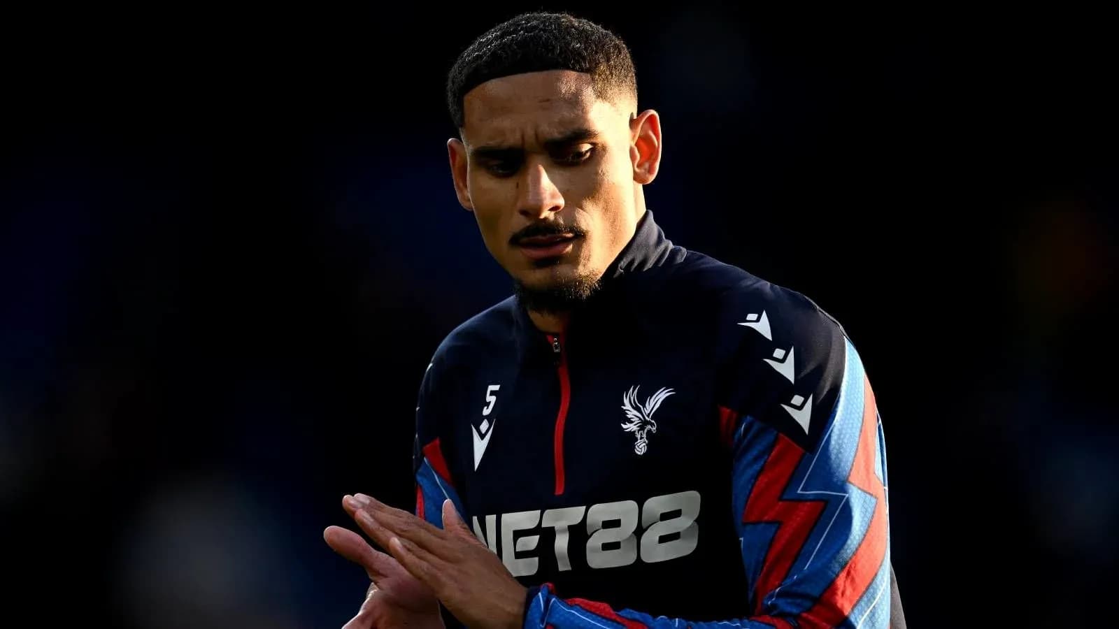 Player in Crystal Palace kit preparing for match Player in Crystal Palace kit preparing for match