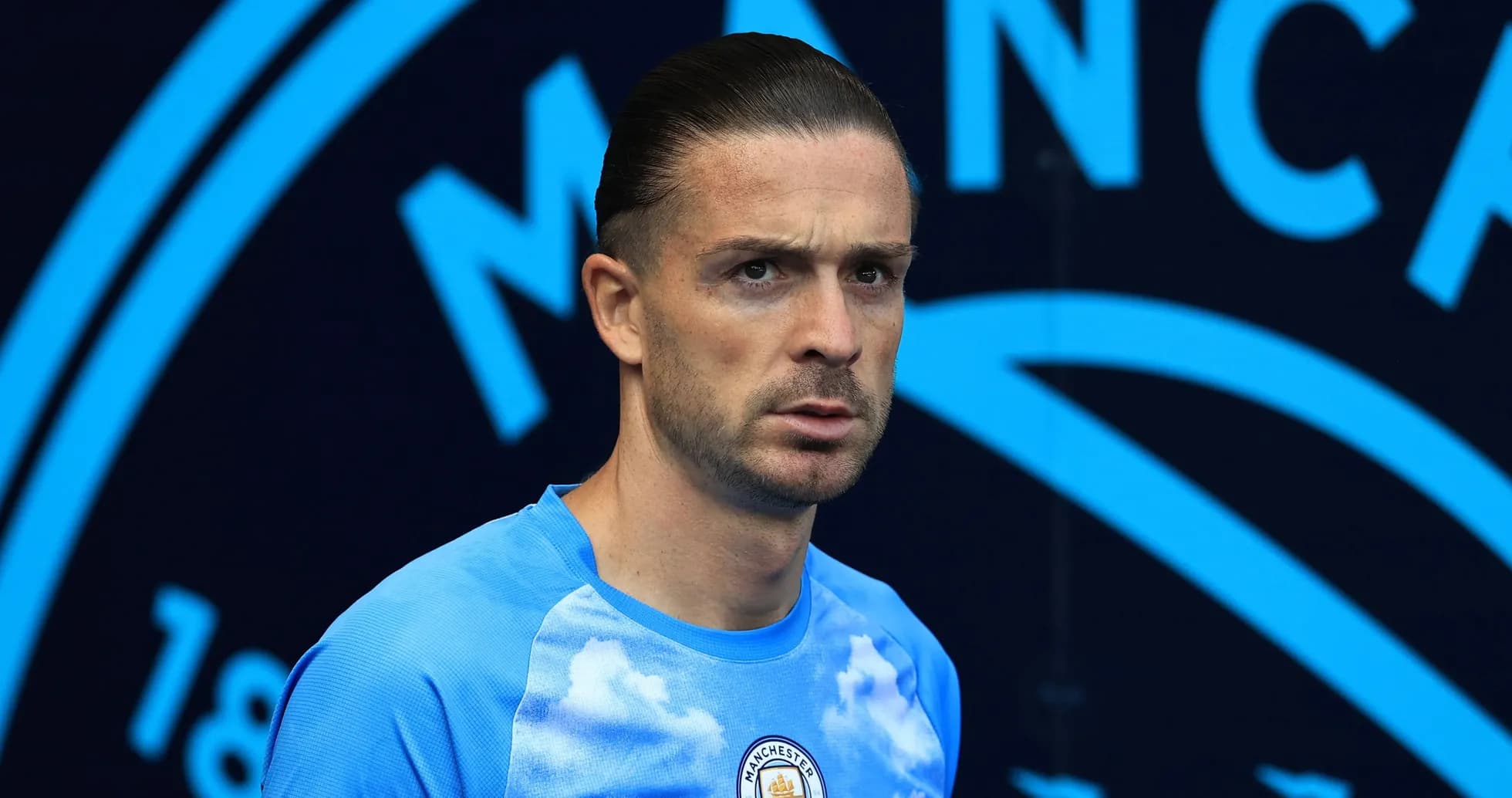 Player in Manchester City training kit on pitch Player in Manchester City training kit on pitch
