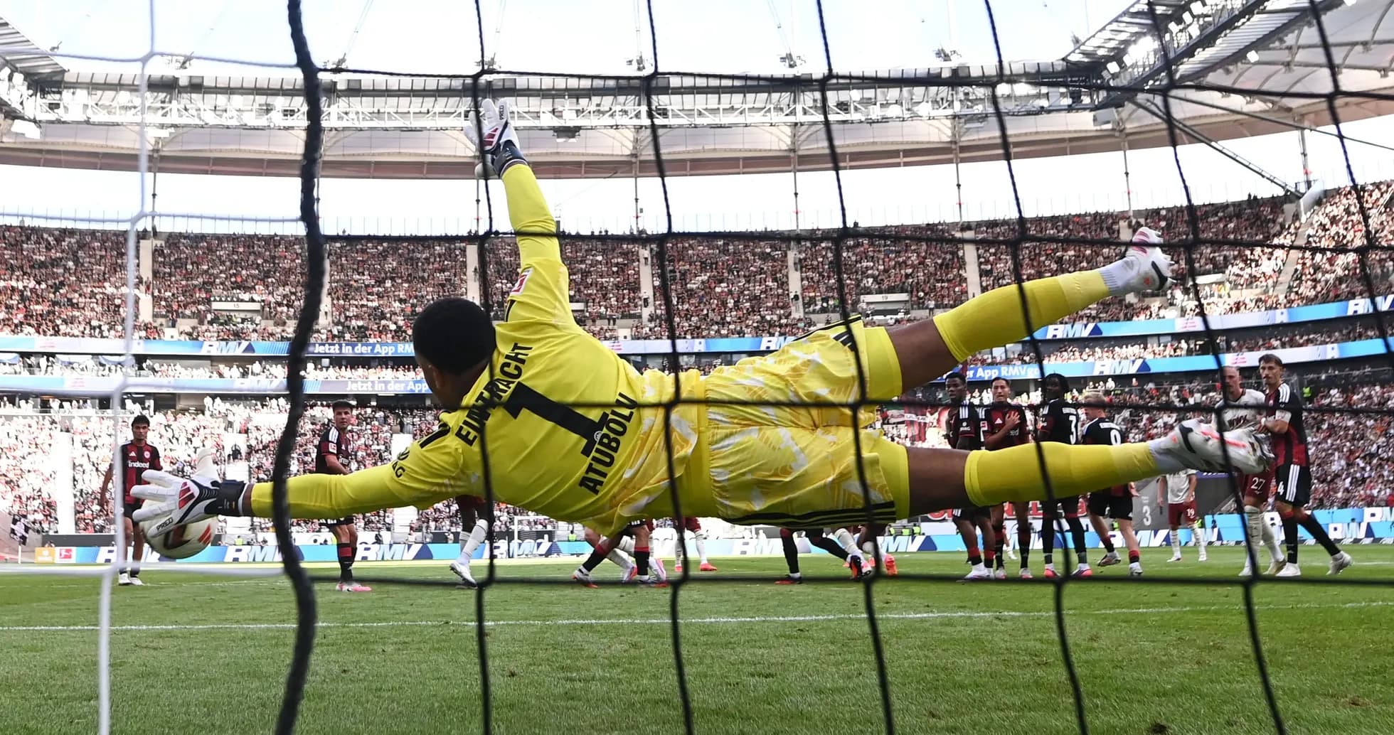 Goalkeeper diving to save a penalty kick Goalkeeper diving to save a penalty kick