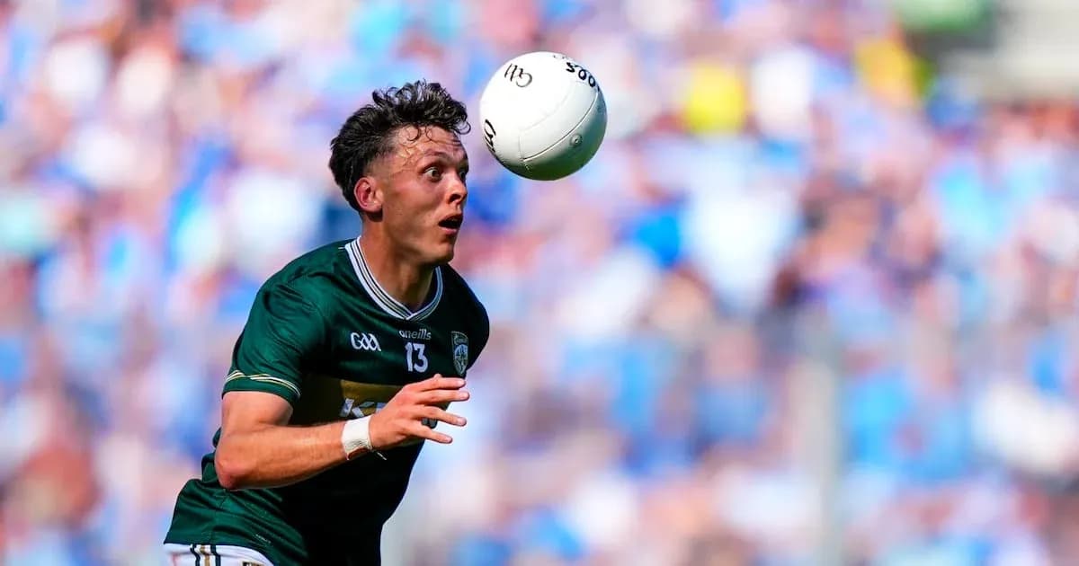 Player attempting to catch a football during match Player attempting to catch a football during match