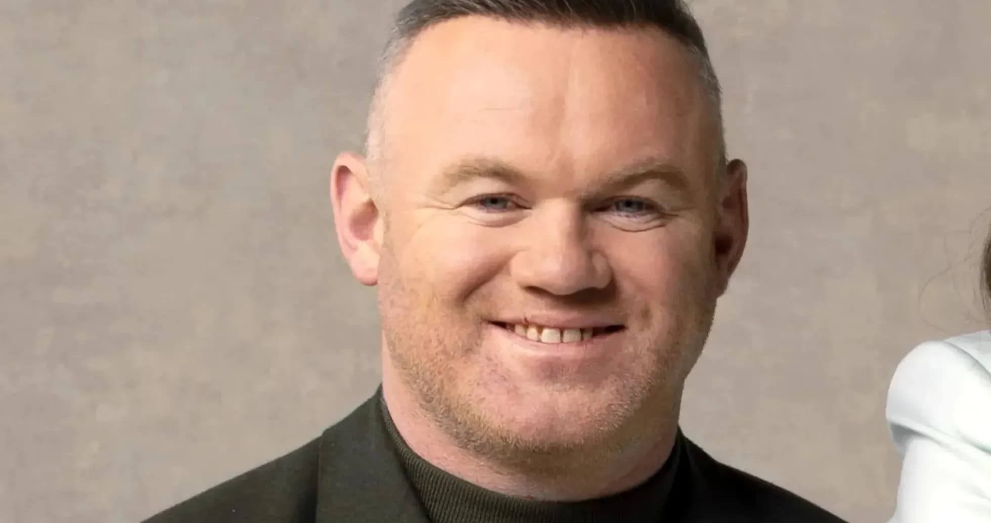 Man smiling in a black jacket against neutral background Man smiling in a black jacket against neutral background