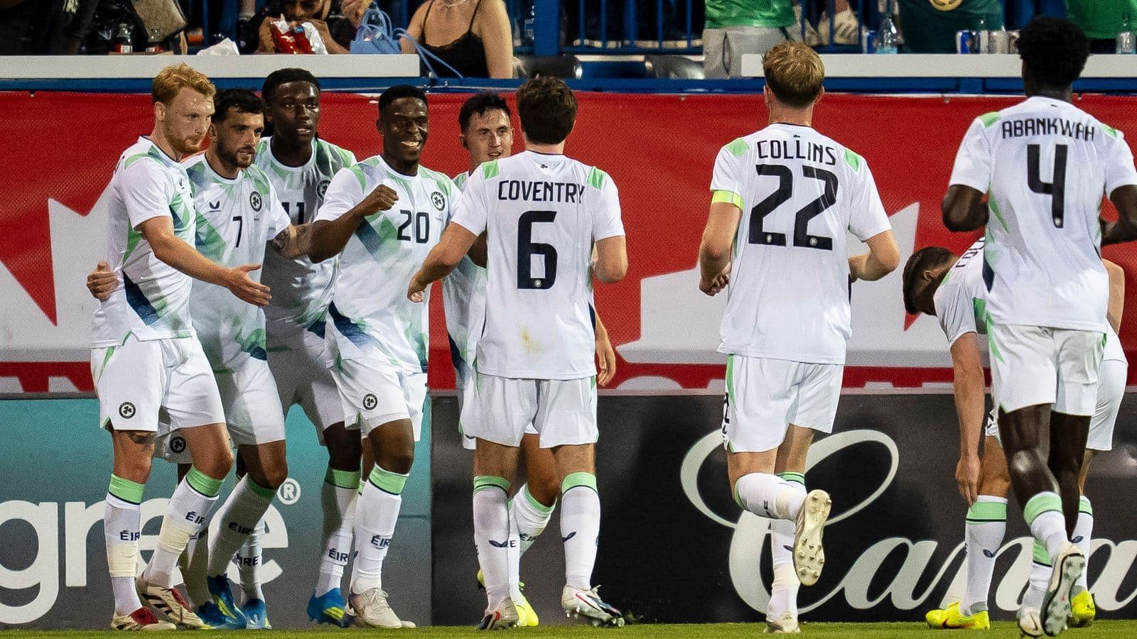 Players celebrating a goal during a soccer match Players celebrating a goal during a soccer match
