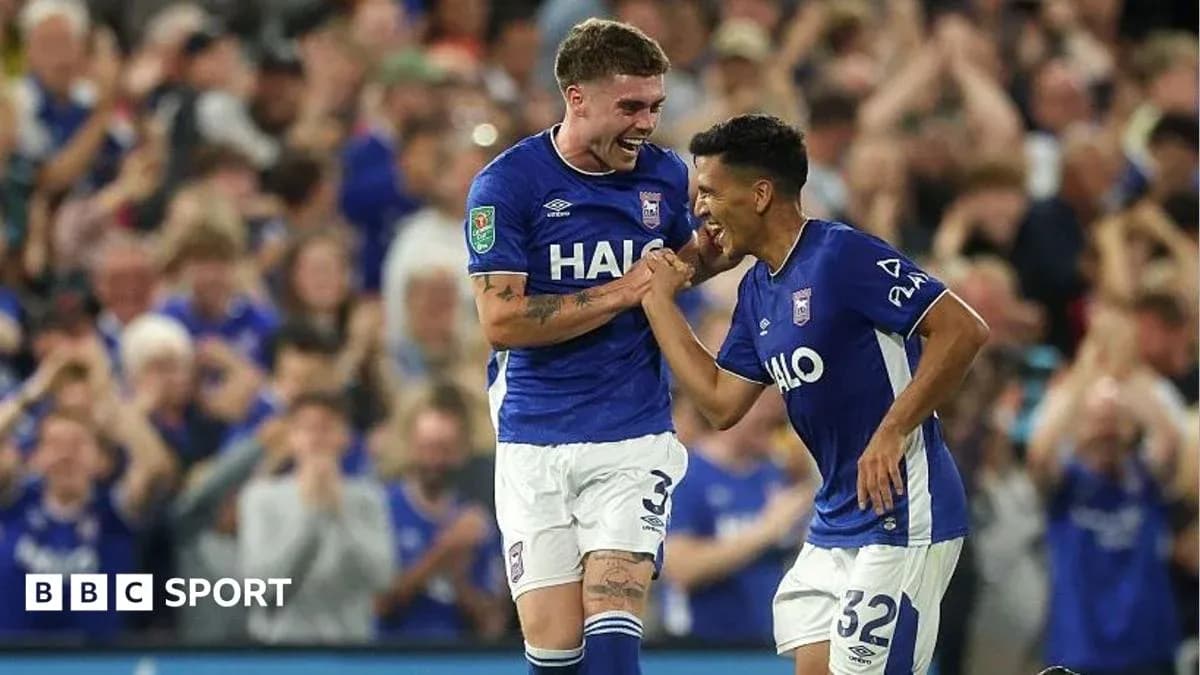 Two Ipswich Town players celebrating a goal together Two Ipswich Town players celebrating a goal together