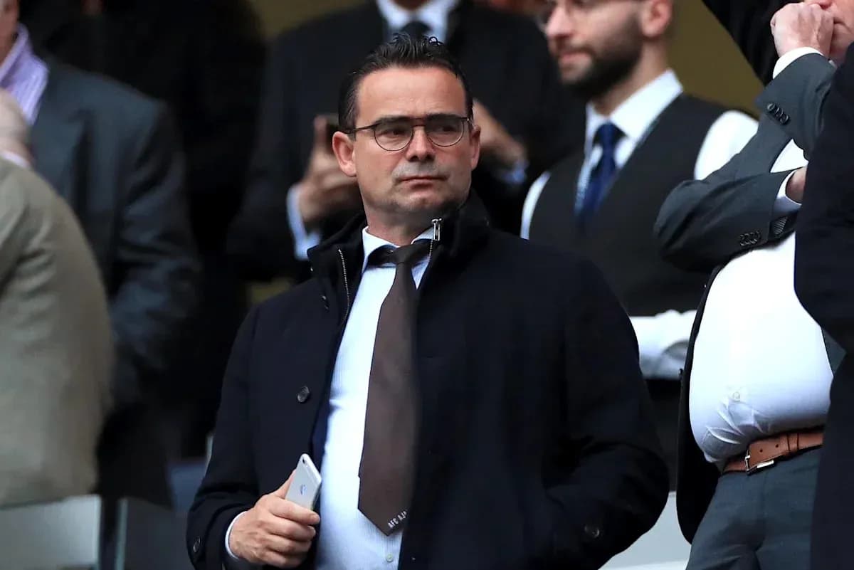 Man in a suit observing from the stands Man in a suit observing from the stands