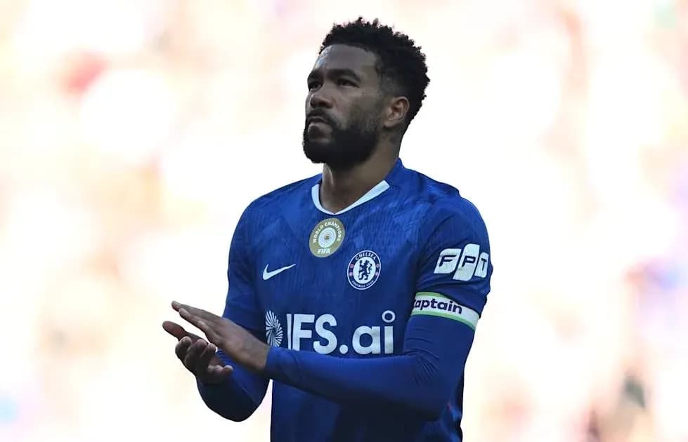 Player in blue jersey with captain's armband Player in blue jersey with captain's armband