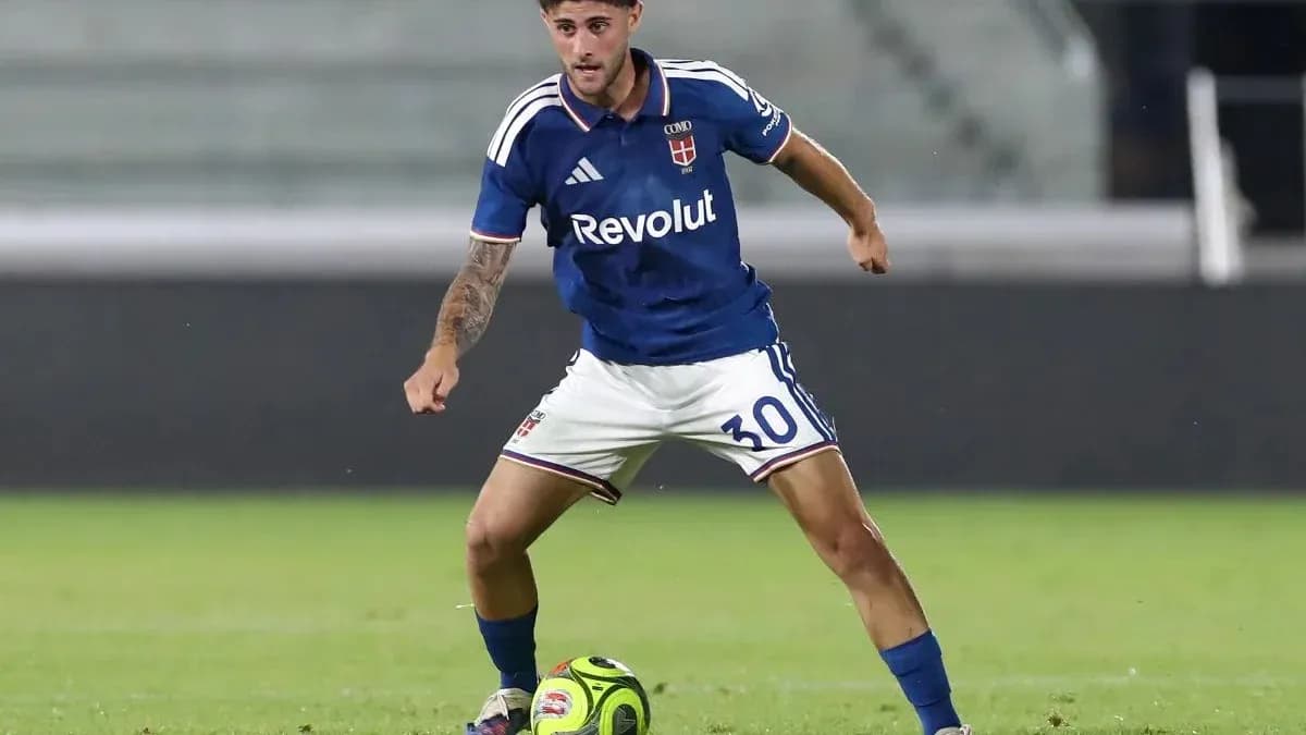 Player in blue kit dribbling a soccer ball Player in blue kit dribbling a soccer ball