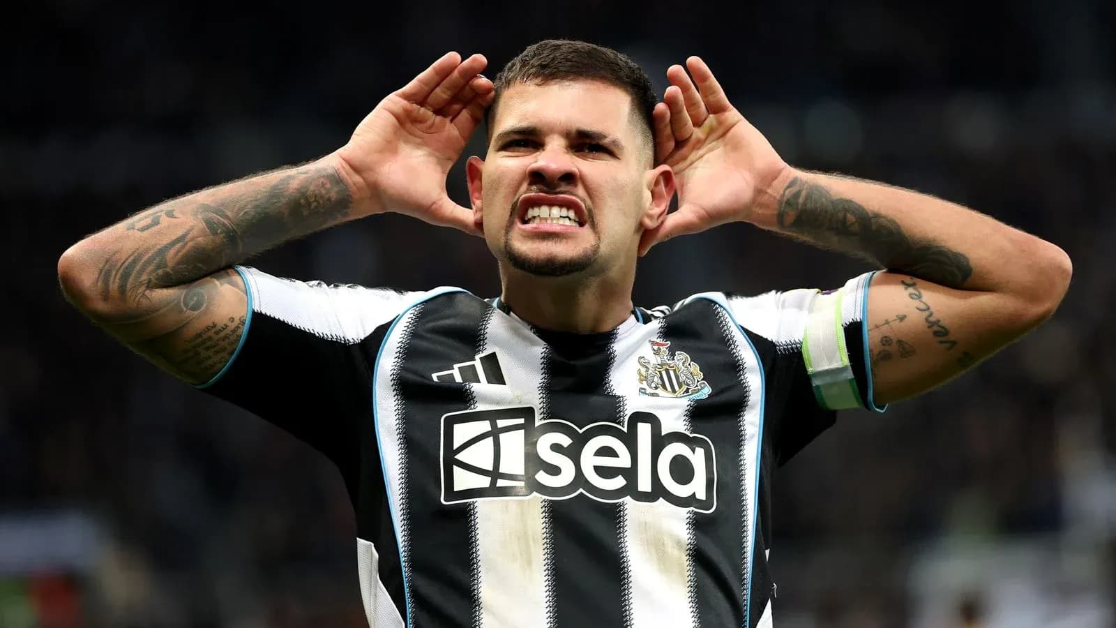 Newcastle player celebrating with hands on ears Newcastle player celebrating with hands on ears