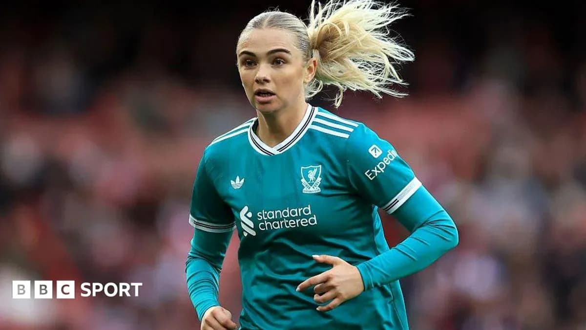 Female football player in Liverpool kit running Female football player in Liverpool kit running