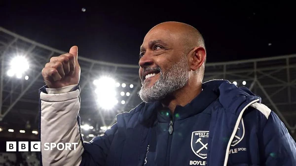 Manager celebrating victory at stadium with raised thumb Manager celebrating victory at stadium with raised thumb
