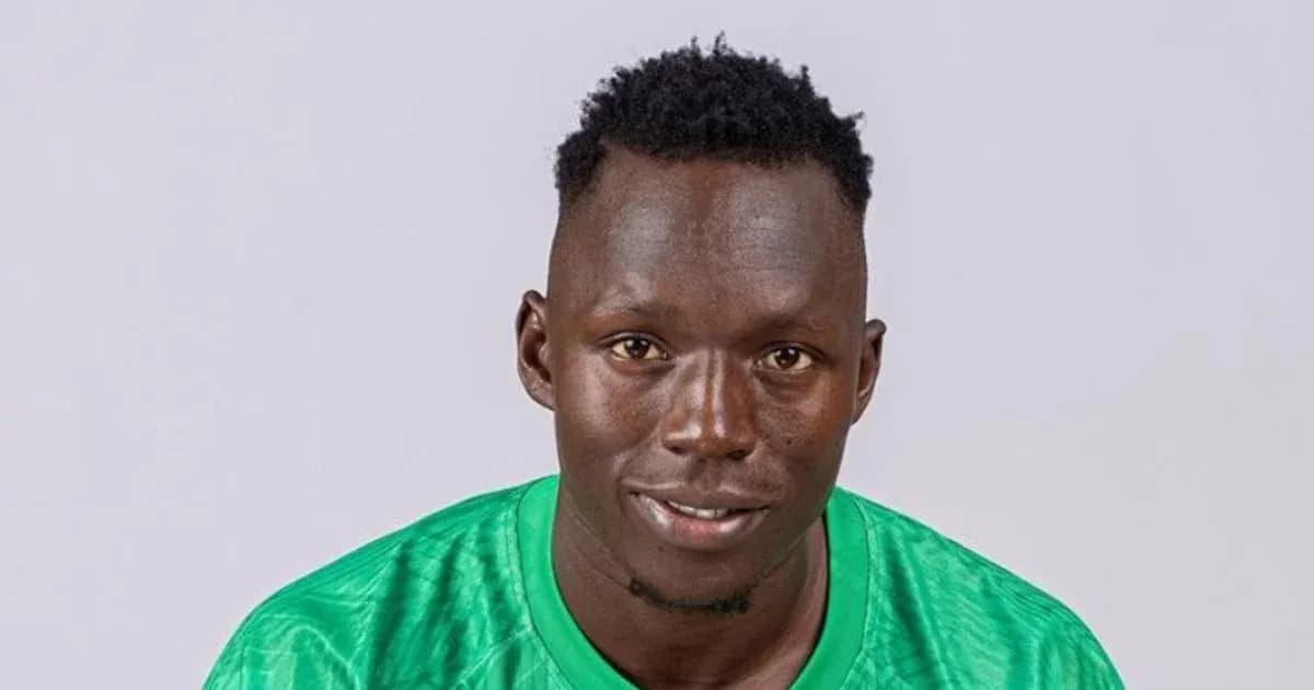 Goalkeeper in green jersey smiling for portrait Goalkeeper in green jersey smiling for portrait