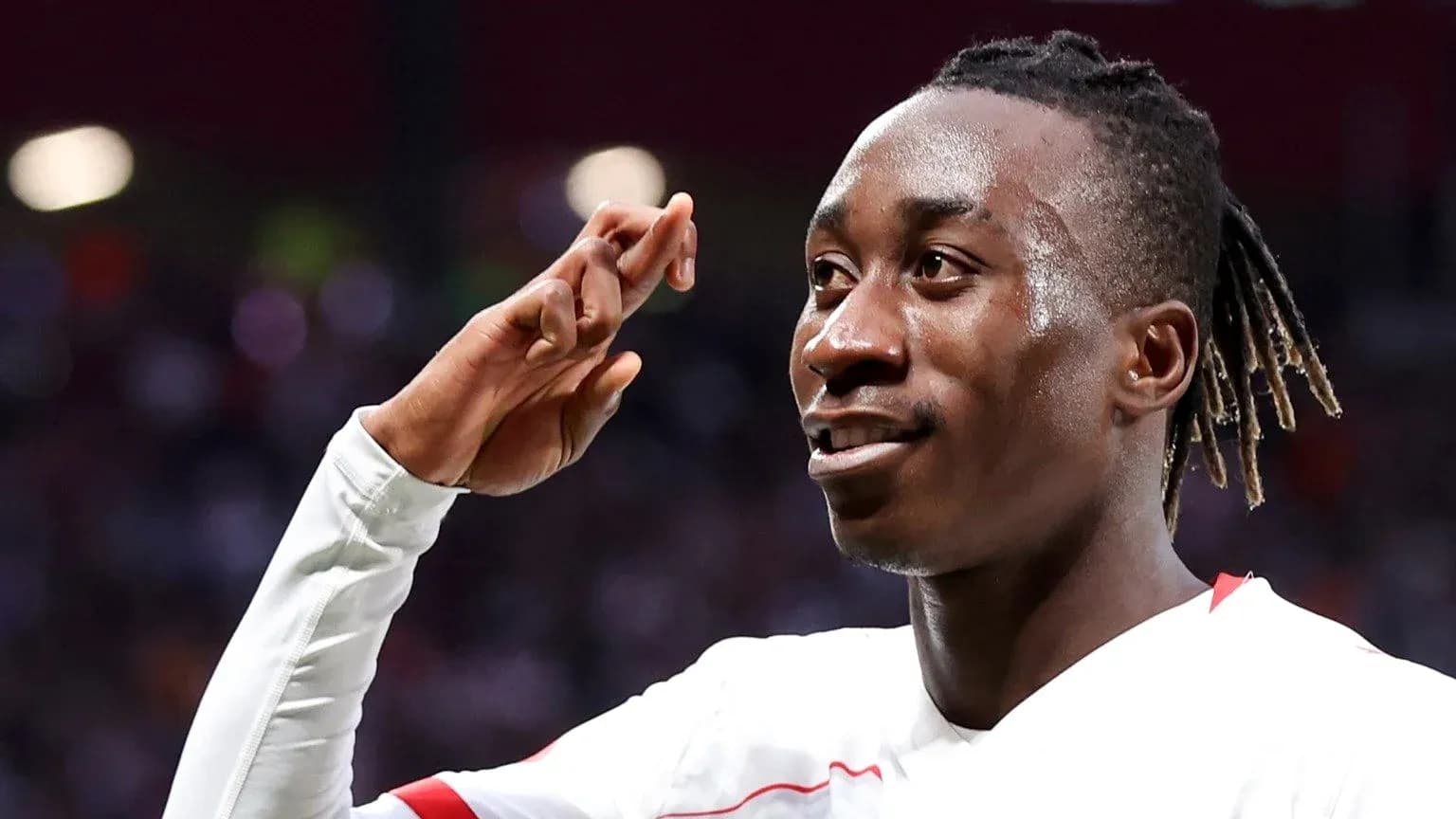 Player celebrating with hand salute after scoring Player celebrating with hand salute after scoring