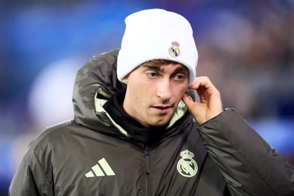 Player wearing Real Madrid jacket and beanie on sidelines Player wearing Real Madrid jacket and beanie on sidelines