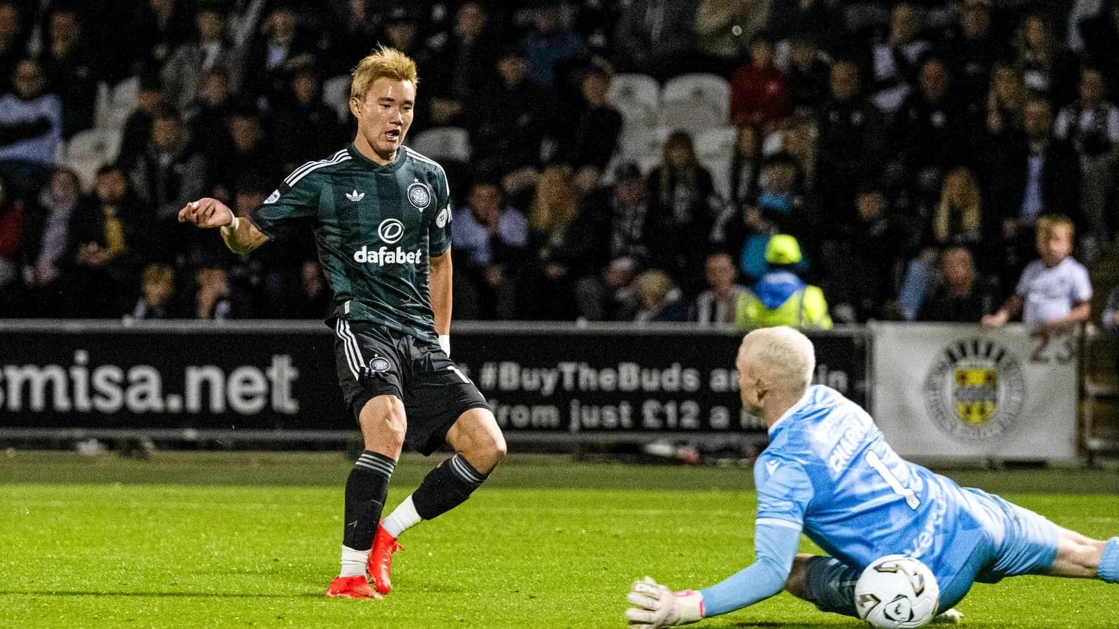 Player dribbling past goalkeeper during match Player dribbling past goalkeeper during match