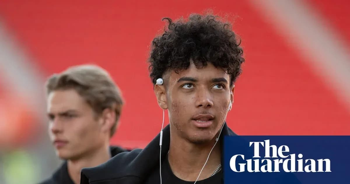 Young player wearing earphones in stadium hallway Young player wearing earphones in stadium hallway