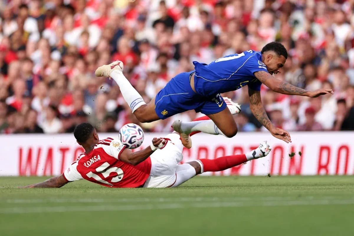 Player falls while challenging for the ball during match Player falls while challenging for the ball during match